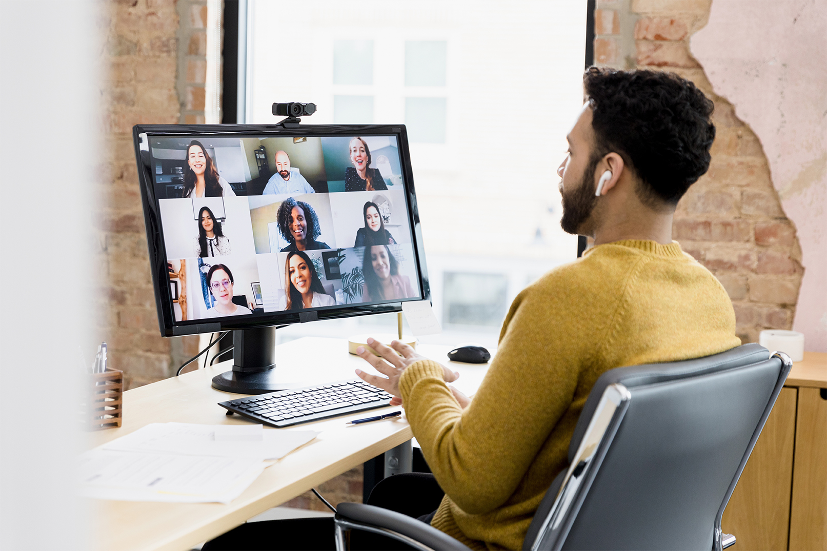 A man participating in a virtual meeting.