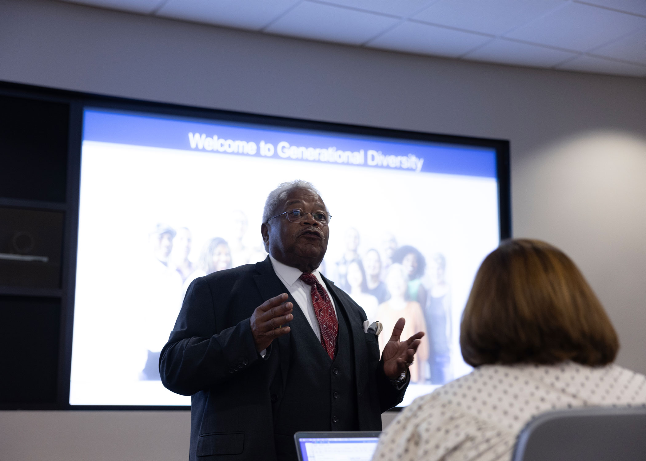 Ron Harris lecturing in front of a projected image titled Welcome to Generational Diversity.